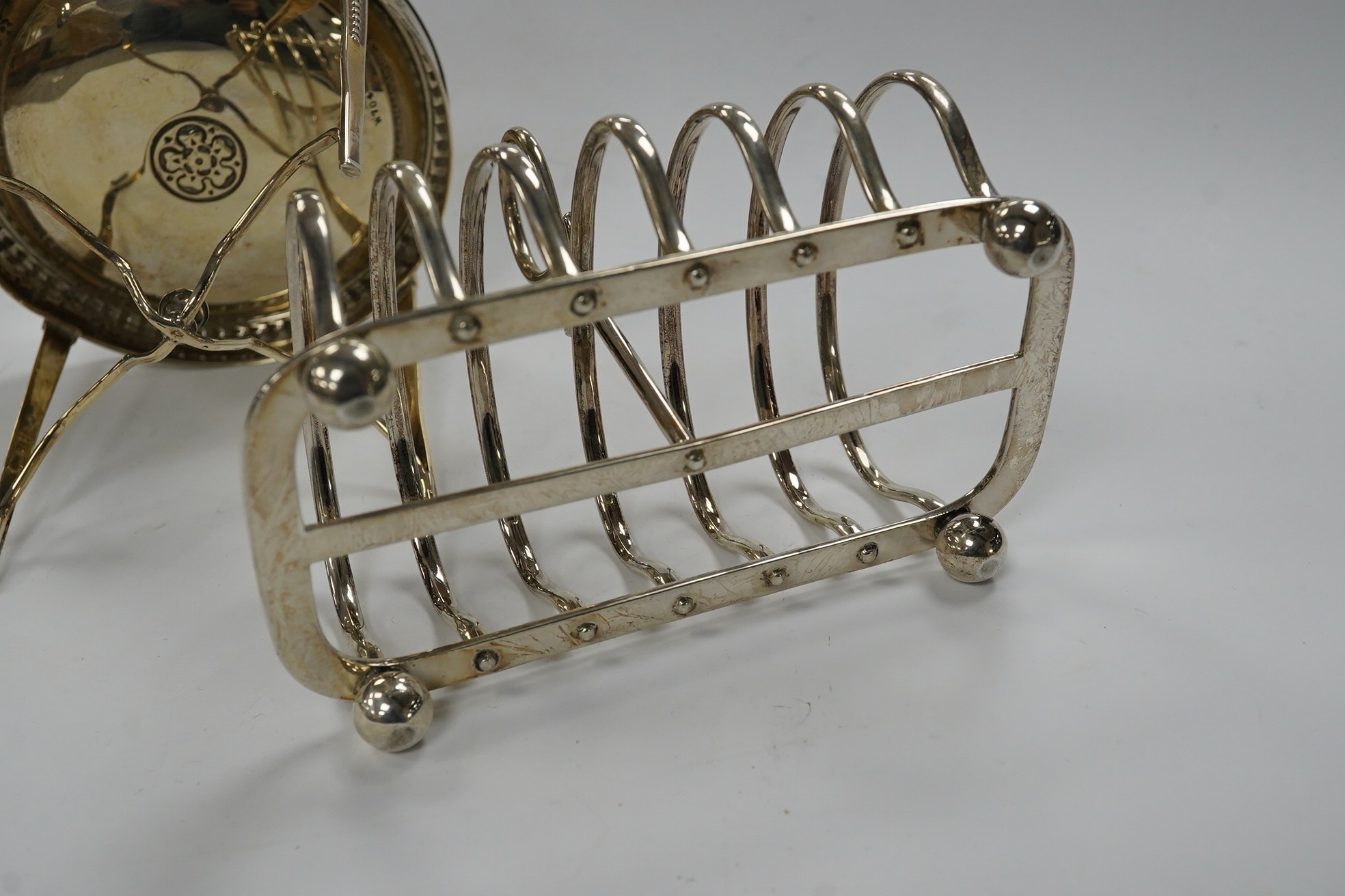 A George V miniature silver model of an occasional table, John Round, Sheffield, 1925, height 9.8cm, together with a similar silver five bar toast rack, 11.3oz. Condition - fair
